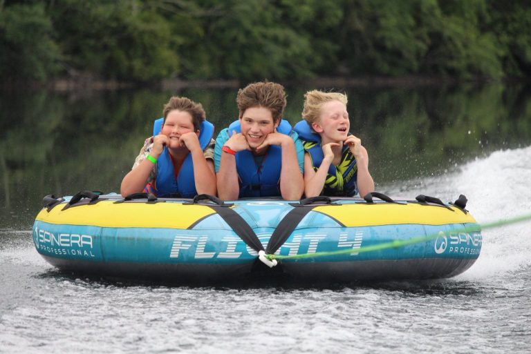 boys riding in an inner tube