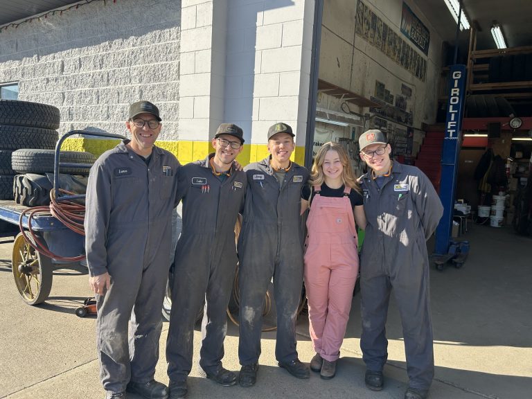family standing in front of mechanic's shop