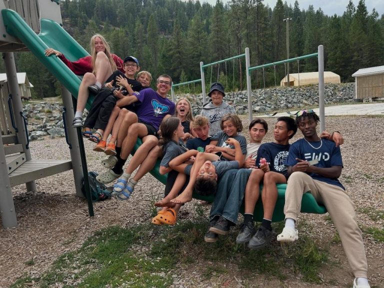 kids sitting on a slide